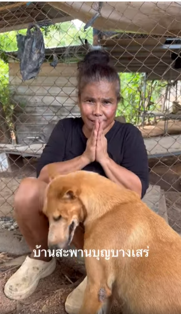 Aunt Khao with one of her rescued dogs at Baan Saphan Boon sanctuary